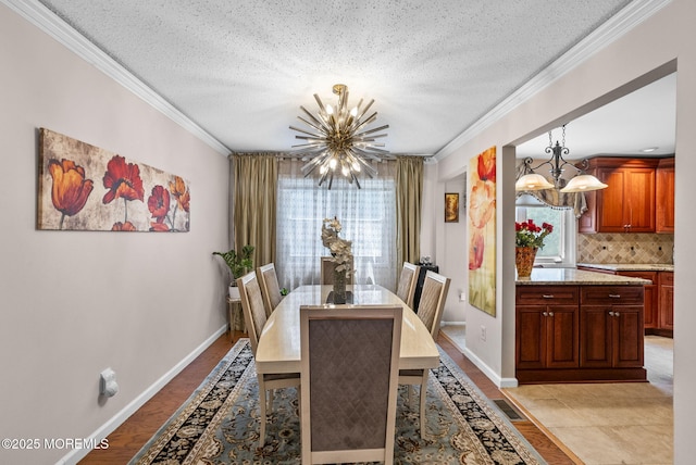 35 Lone Star Ln, Manalapan, NJ 07726 - dining space featuring a chandelier, plenty of natural light, a textured ceiling, ornamental molding, and baseboards