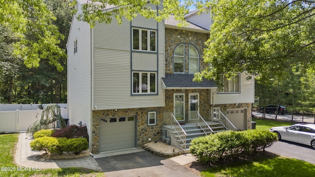 35 Lone Star Ln, Manalapan, NJ 07726 - view of front of property with stone siding, a garage, and asphalt driveway