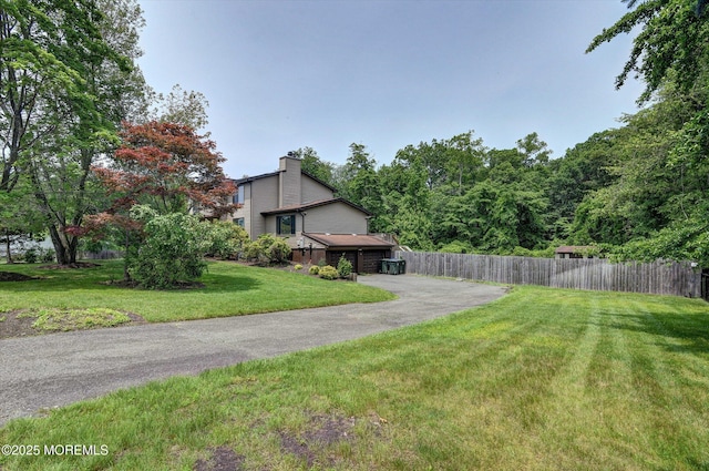 19 Northwoods Rd, Ocean Twp, NJ 07712 - view of yard featuring asphalt driveway
