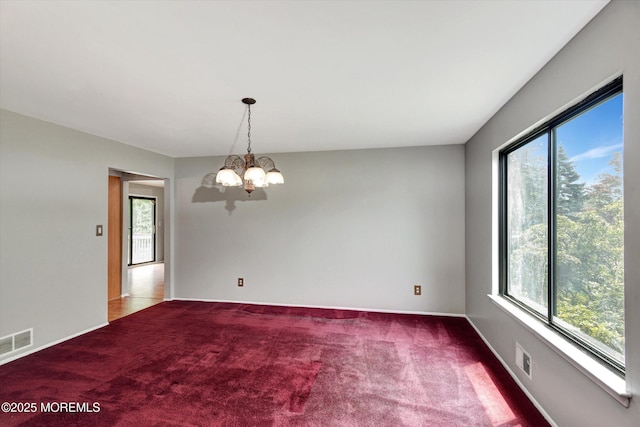 19 Northwoods Rd, Ocean Twp, NJ 07712 - unfurnished room with healthy amount of natural light, a chandelier, and carpet