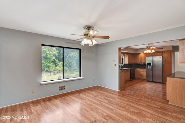 19 Northwoods Rd, Ocean Twp, NJ 07712 - kitchen with stainless steel fridge with ice dispenser, a ceiling fan, dark countertops, light wood finished floors, and dishwasher