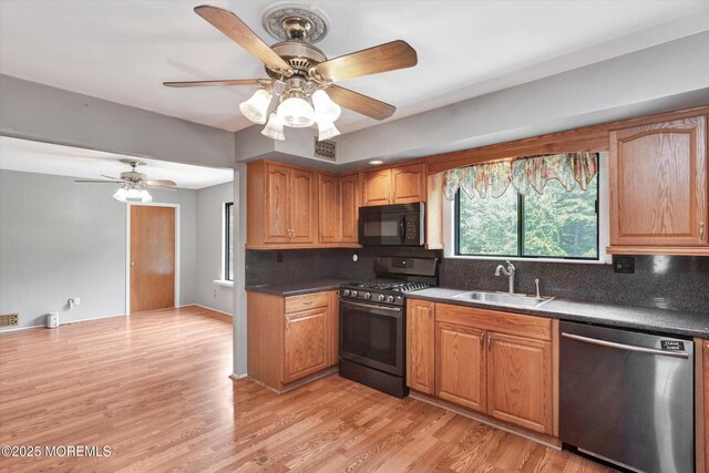 19 Northwoods Rd, Ocean Twp, NJ 07712 - kitchen with appliances with stainless steel finishes, decorative backsplash, a ceiling fan, and light wood-style flooring