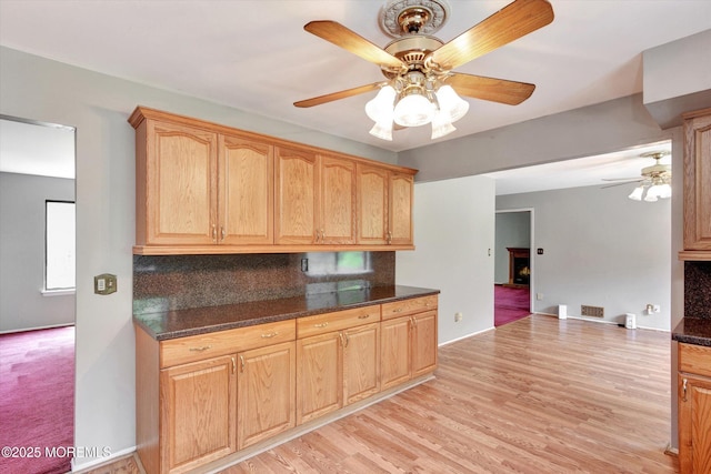 19 Northwoods Rd, Ocean Twp, NJ 07712 - kitchen featuring ceiling fan, dark countertops, decorative backsplash, and light wood-style floors