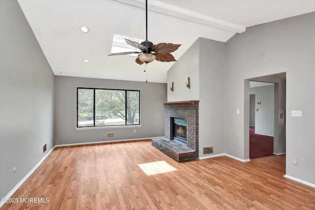 19 Northwoods Rd, Ocean Twp, NJ 07712 - unfurnished living room with light wood-style flooring, a brick fireplace, a ceiling fan, and a skylight