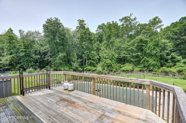 19 Northwoods Rd, Ocean Twp, NJ 07712 - wooden deck with a fenced backyard and a swimming pool