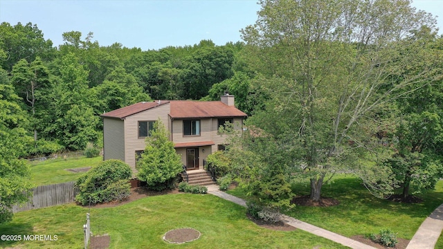 19 Northwoods Rd, Ocean Twp, NJ 07712 - view of front facade featuring a chimney and a wooded view