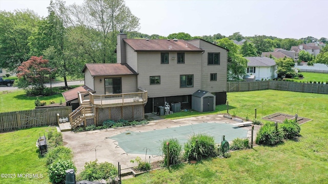 19 Northwoods Rd, Ocean Twp, NJ 07712 - rear view of house with a storage unit, a deck, a fenced backyard, a patio area, and a chimney