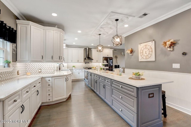 3 Kindling Way, Jackson, NJ 08527 - kitchen with gray cabinets, wall chimney exhaust hood, white cabinetry, ornamental molding, and tasteful backsplash