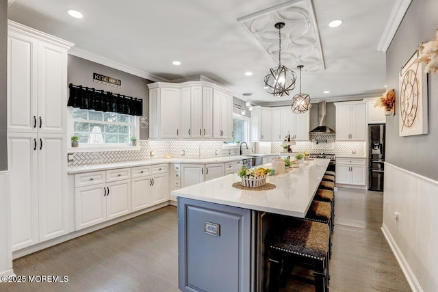 3 Kindling Way, Jackson, NJ 08527 - kitchen featuring black fridge, wall chimney range hood, white cabinets, light wood-type flooring, and crown molding