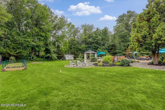 3 Kindling Way, Jackson, NJ 08527 - view of green lawn featuring a gazebo, a vegetable garden, a shed, and a patio area