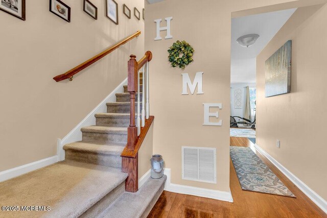 9 Olivia Dr, Tinton Falls, NJ 07712 - stairway featuring wood finished floors and baseboards