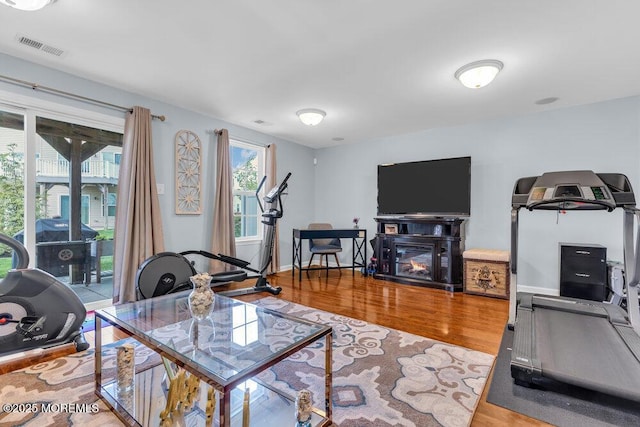 9 Olivia Dr, Tinton Falls, NJ 07712 - living area with wood finished floors and a glass covered fireplace