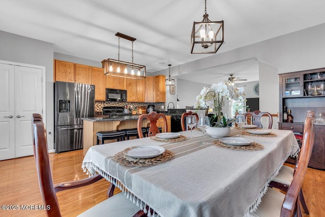 9 Olivia Dr, Tinton Falls, NJ 07712 - dining room featuring light wood-type flooring, a chandelier, and a ceiling fan
