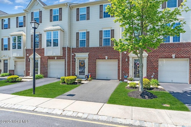 9 Olivia Dr, Tinton Falls, NJ 07712 - view of property with driveway, brick siding, and an attached garage