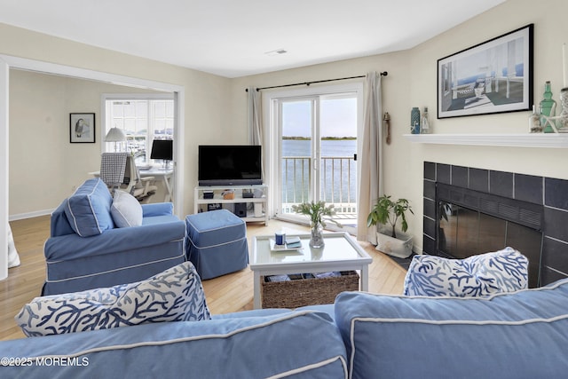 310 S W Ave Unit K1, Beach Haven, NJ 08008 - living room with healthy amount of natural light, wood finished floors, and a tiled fireplace