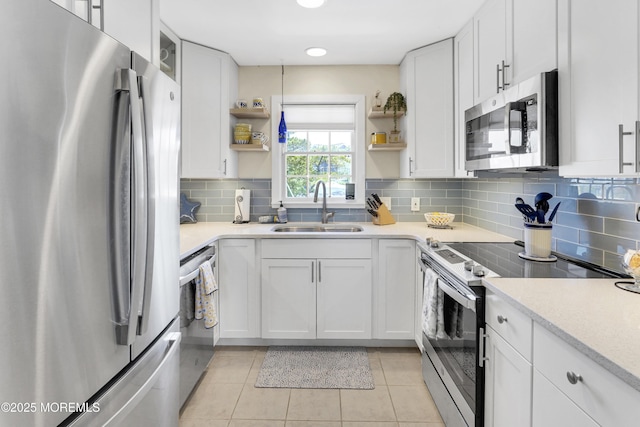 310 S W Ave Unit K1, Beach Haven, NJ 08008 - kitchen with stainless steel appliances, open shelves, white cabinets, tasteful backsplash, and light countertops