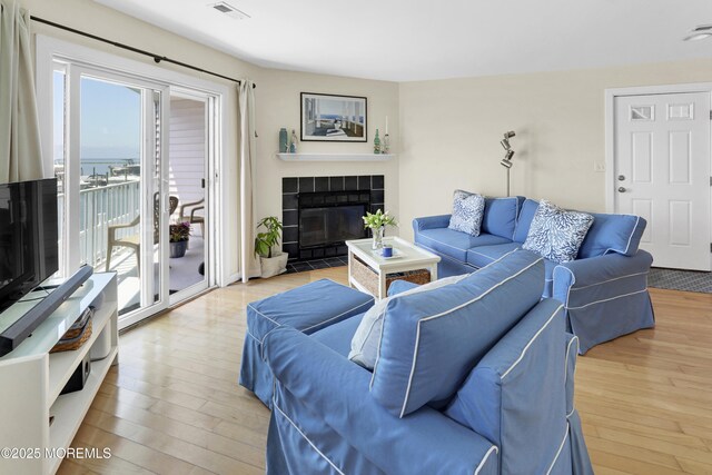 310 S W Ave Unit K1, Beach Haven, NJ 08008 - living room featuring hardwood / wood-style flooring and a tiled fireplace