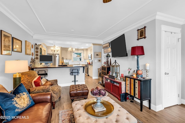 75 Farnworth Close Unit 1000, Freehold, NJ 07728 - living area featuring a chandelier, light wood-type flooring, crown molding, and baseboards