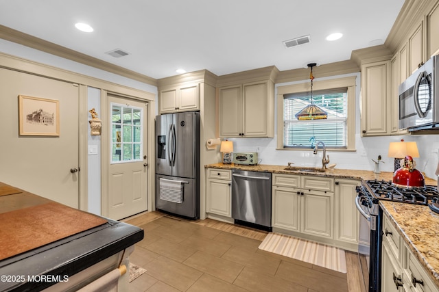 75 Farnworth Close Unit 1000, Freehold, NJ 07728 - kitchen featuring appliances with stainless steel finishes, cream cabinetry, a sink, light tile patterned floors, and light stone counters