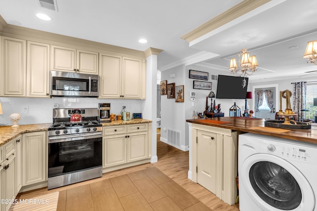 75 Farnworth Close Unit 1000, Freehold, NJ 07728 - kitchen with appliances with stainless steel finishes, washer / dryer, cream cabinetry, crown molding, and recessed lighting