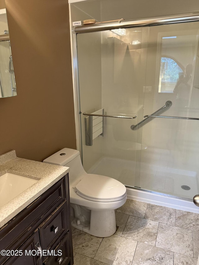 300 Allenhurst Ave, Neptune Township, NJ 07753 - bathroom featuring vanity, toilet, and a stall shower
