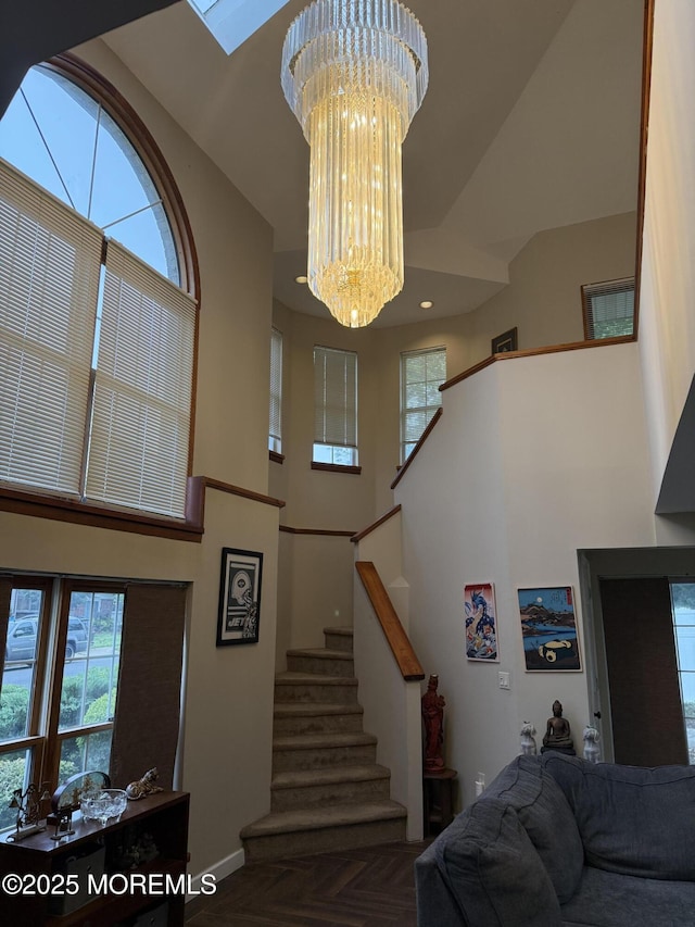 300 Allenhurst Ave, Neptune Township, NJ 07753 - staircase with a high ceiling, a chandelier, healthy amount of natural light, baseboards, and a skylight