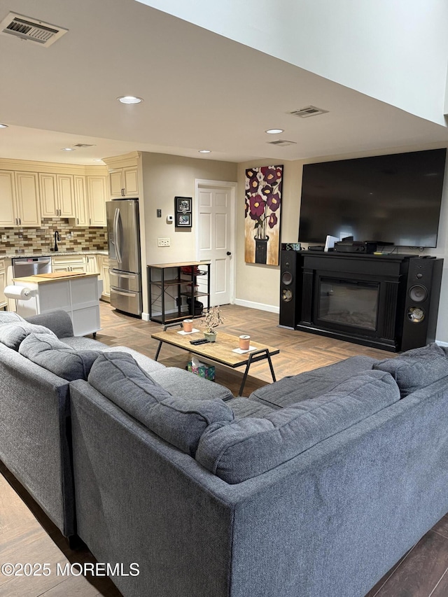300 Allenhurst Ave, Neptune Township, NJ 07753 - living room with recessed lighting, baseboards, a glass covered fireplace, and light wood-style flooring