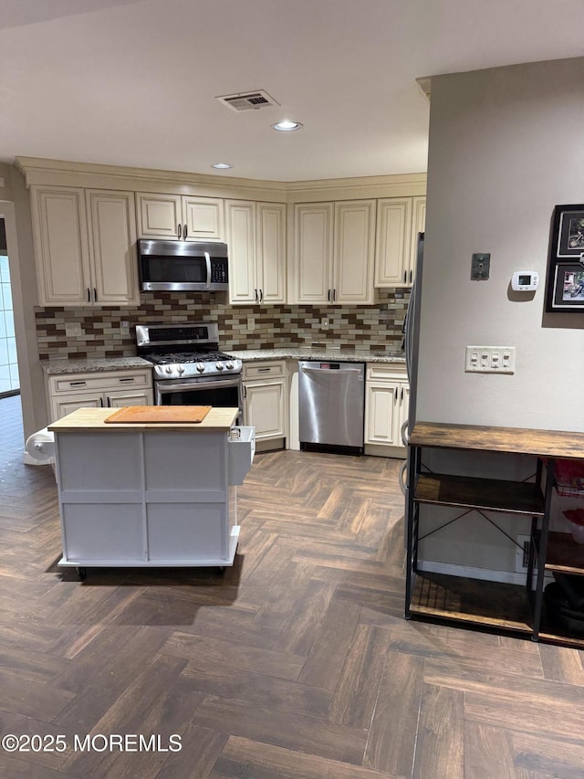 300 Allenhurst Ave, Neptune Township, NJ 07753 - kitchen with stainless steel appliances, tasteful backsplash, cream cabinetry, and recessed lighting