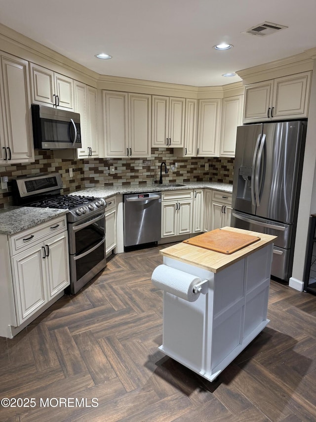 300 Allenhurst Ave, Neptune Township, NJ 07753 - kitchen featuring appliances with stainless steel finishes, a sink, backsplash, light stone counters, and recessed lighting