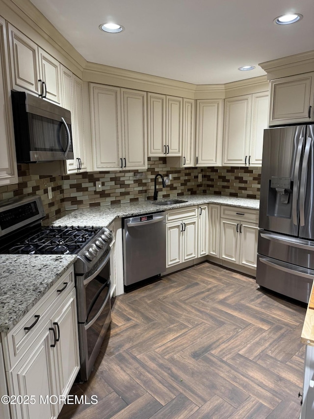 300 Allenhurst Ave, Neptune Township, NJ 07753 - kitchen featuring stainless steel appliances, a sink, backsplash, cream cabinetry, and recessed lighting