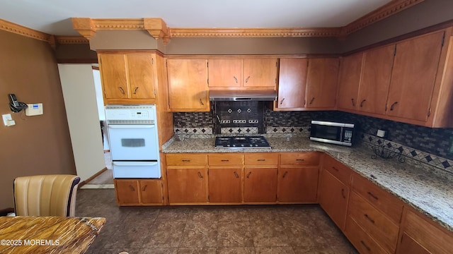 354 Alpine St, Perth Amboy City, NJ 08861 - kitchen with appliances with stainless steel finishes, a warming drawer, tasteful backsplash, under cabinet range hood, and brown cabinets
