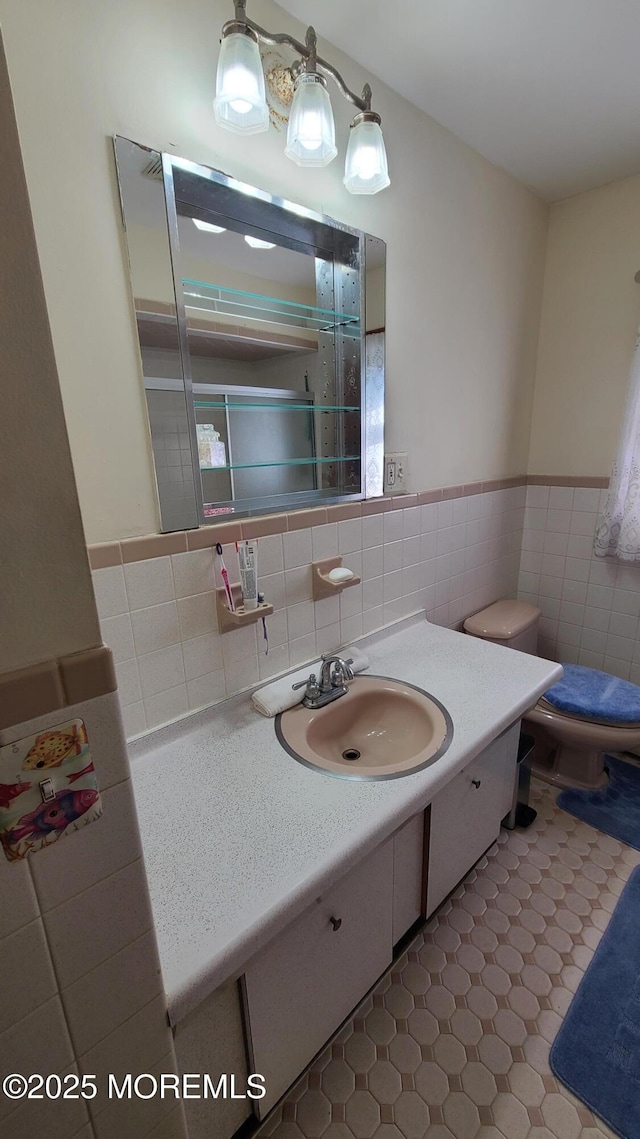 354 Alpine St, Perth Amboy City, NJ 08861 - bathroom featuring tile walls, vanity, and a wainscoted wall