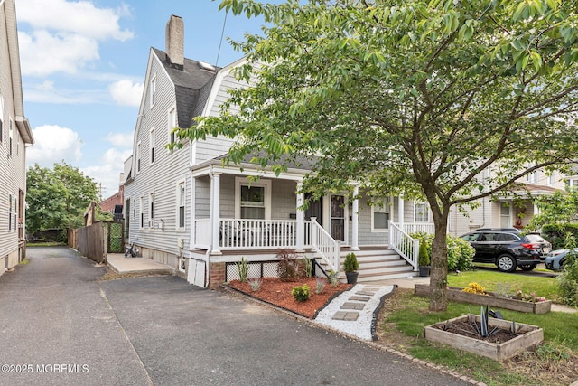 51 Oakland St, Red Bank, NJ 07701 - view of front of house with a porch, a gambrel roof, a chimney, and roof with shingles