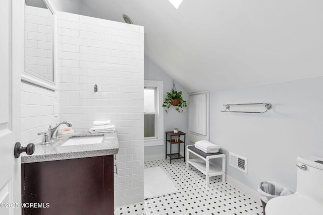 51 Oakland St, Red Bank, NJ 07701 - bathroom with vanity, vaulted ceiling, toilet, and baseboards