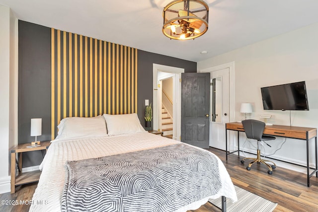 51 Oakland St, Red Bank, NJ 07701 - bedroom featuring wood finished floors, a chandelier, a desk, and baseboards