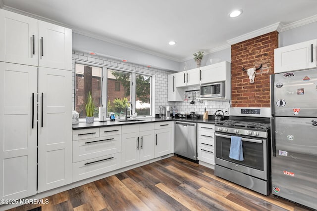 51 Oakland St, Red Bank, NJ 07701 - kitchen featuring stainless steel appliances, a sink, dark countertops, crown molding, and backsplash