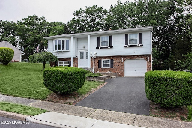 18 Kingsport Dr, Howell, NJ 07731 - split foyer home featuring brick siding, a garage, a front lawn, and driveway