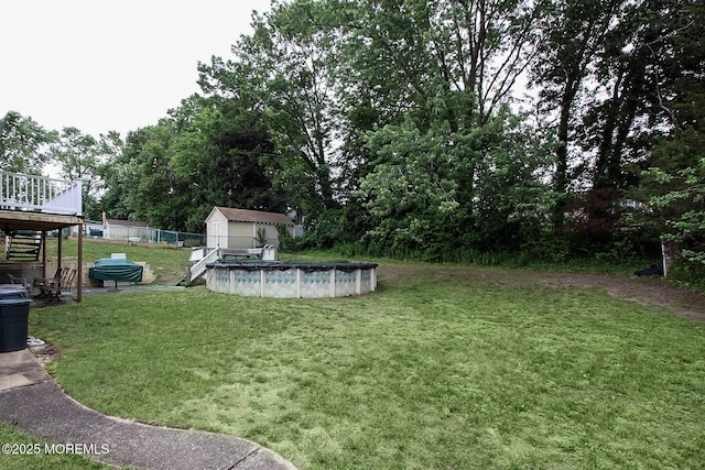 18 Kingsport Dr, Howell, NJ 07731 - view of green lawn featuring a wooden deck, a shed, and a covered pool