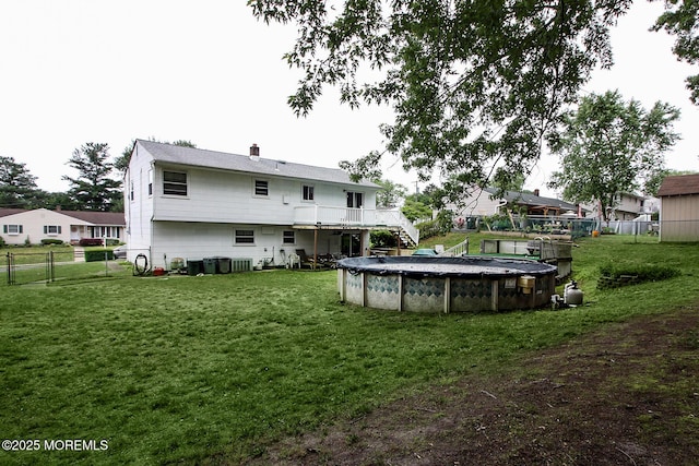 18 Kingsport Dr, Howell, NJ 07731 - rear view of house featuring stairs, a fenced backyard, a wooden deck, a covered pool, and a chimney