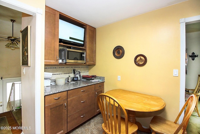 18 Kingsport Dr, Howell, NJ 07731 - kitchen with stainless steel microwave, tasteful backsplash, and ceiling fan