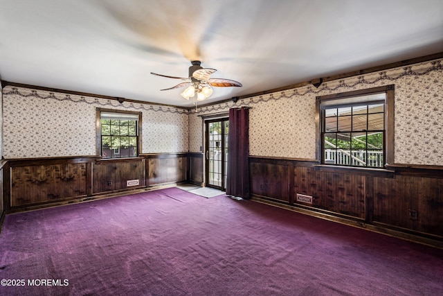 66 Cedar Swamp Rd, Jackson, NJ 08527 - spare room with a wainscoted wall, ceiling fan, wallpapered walls, carpet floors, and crown molding