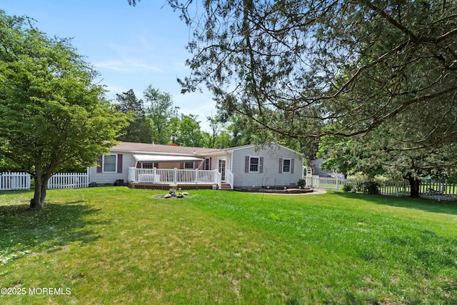 66 Cedar Swamp Rd, Jackson, NJ 08527 - rear view of property with a wooden deck, a fenced backyard, and a fire pit