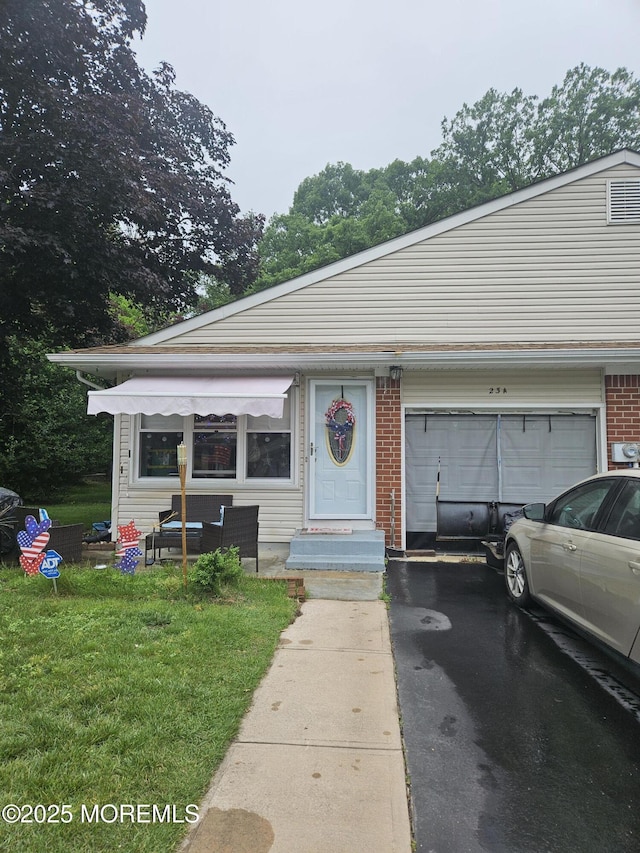 23 Snowberry Ln Unit A, Whiting, NJ 08759 - view of front of property with asphalt driveway, an attached garage, and a front lawn