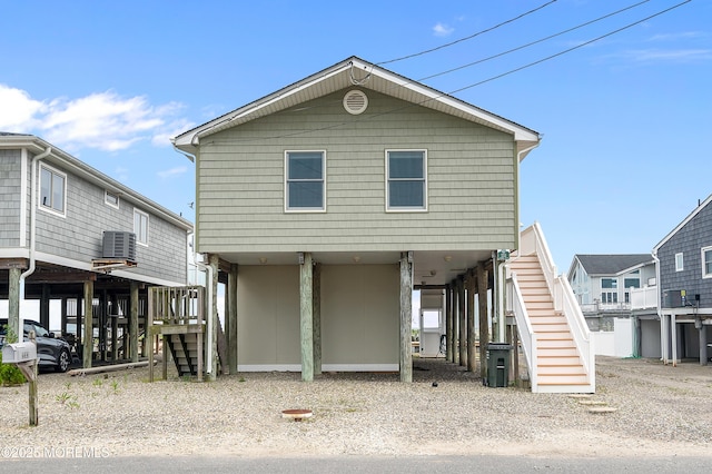 233 Heron Rd, Tuckerton, NJ 08087 - view of front of house with stairway, a carport, central AC, and gravel driveway