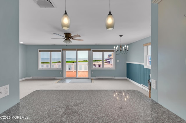 233 Heron Rd, Tuckerton, NJ 08087 - carpeted empty room with a baseboard heating unit, a chandelier, ceiling fan, and wainscoting