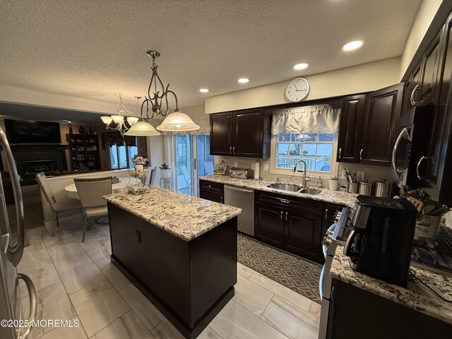 4 Hemlock Hill Rd, Jackson, NJ 08527 - kitchen with appliances with stainless steel finishes, a sink, a center island, light stone countertops, and a textured ceiling