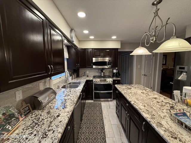 4 Hemlock Hill Rd, Jackson, NJ 08527 - kitchen with appliances with stainless steel finishes, a sink, light stone countertops, decorative backsplash, and decorative light fixtures