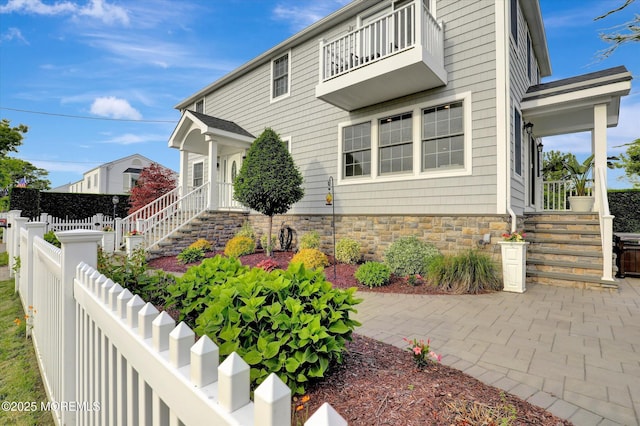 206 Chicago Ave, Point Pleasant Beach, NJ 08742 - traditional-style house featuring a balcony, stairway, and stone siding