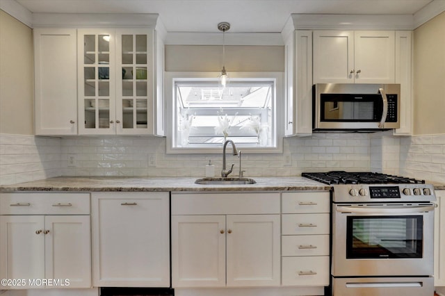206 Chicago Ave, Point Pleasant Beach, NJ 08742 - kitchen featuring stainless steel appliances, a sink, white cabinetry, and backsplash