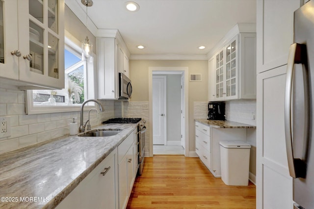206 Chicago Ave, Point Pleasant Beach, NJ 08742 - kitchen featuring stainless steel appliances, a sink, white cabinetry, decorative backsplash, and light stone counters